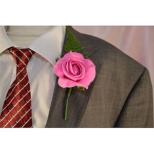Fuchsia single artificial rose buttonhole with fern